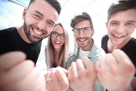 Friends celebrate the victory in the officeの写真素材