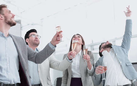 group of happy employees celebrate their success in the workplaceの写真素材