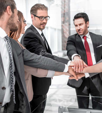 Happy business team showing unity
