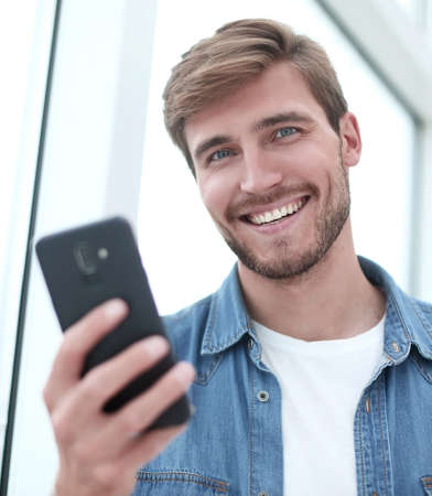close up. young man reading e-mail on his smartphone.