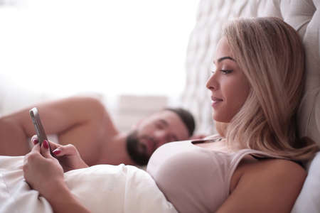 young woman reading a correspondence in the family bedroom.