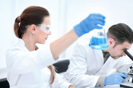 Two scientists are working in laboratory.