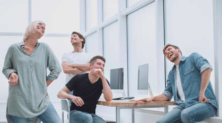 cheerful team of young people in the workplace.
