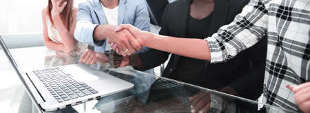 Multiracial peoples celebrating victory watching online results of price growth on laptop.の写真素材