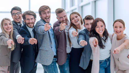 group of happy young business people pointing at youの写真素材