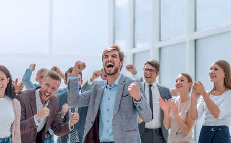 cheerful employees congratulating a colleague on the promotion