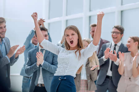 close up. jubilant business team applauding their victory.の写真素材