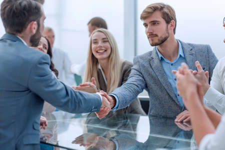 business team applauding the handshake of business partners.の写真素材