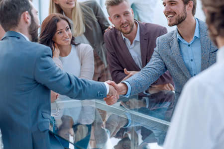 business people greet each other with a handshake