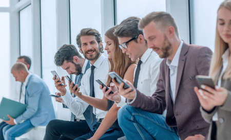group of diverse young people sitting in the office lobby
