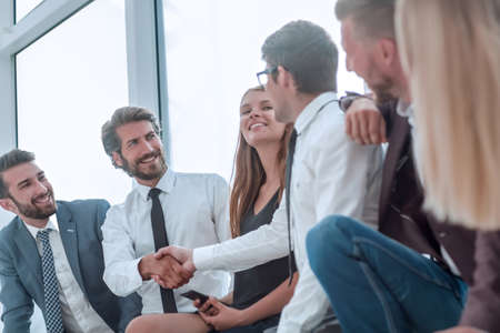 business colleagues shaking hands in the lobby of the business centerの写真素材