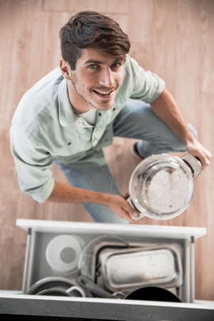 top view. a man taking out utensils from kitchen table