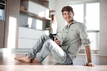young man reading messages on his smartphoneの写真素材