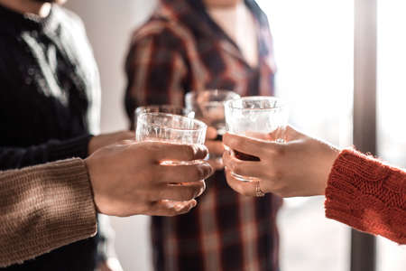 background image of a glass of juice in the hands of the young couple. photo with copy spaceの写真素材