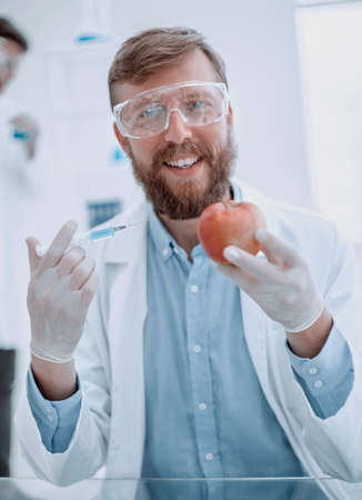 close up. the young scientist, the expert, testing the applesの写真素材
