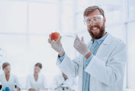 expert with an Apple standing in the laboratoryの写真素材