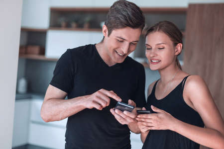 close up. young couple reading email on smartphone.の写真素材