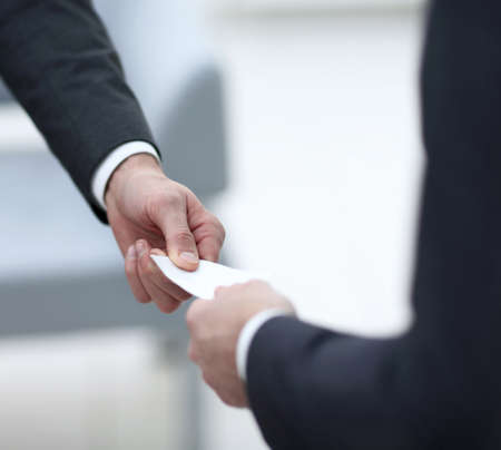 closeup.businessman handing business card to the partner.の写真素材