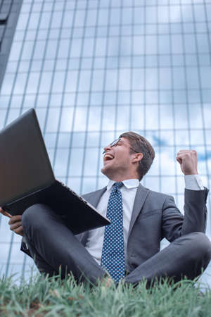 happy businessman looking at his laptop screen