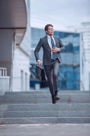 serious business man walking on city street.の写真素材