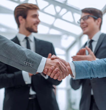 close up. business partners, confidently shaking handsの写真素材