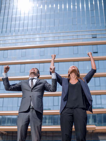 happy young professionals standing near a large office building. photo with copy spaceの写真素材