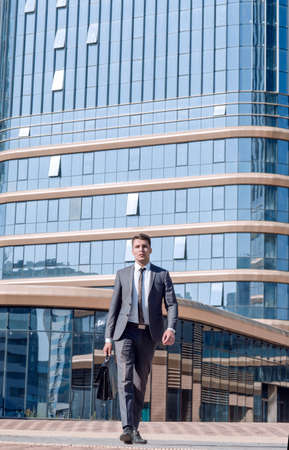 confident business man leaving the building of the business center.の写真素材