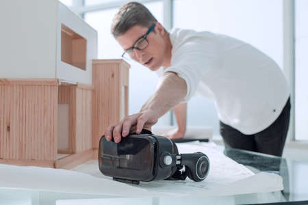 close up. the interior designer takes a virtual reality helmet
