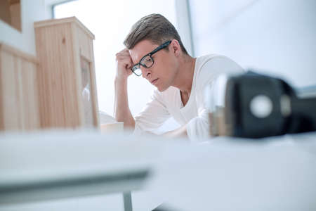serious young designer pondering ideas for a new projectの写真素材