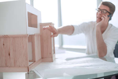 close up.smiling designer with smartphone looking at new layout .photo with copy spaceの写真素材