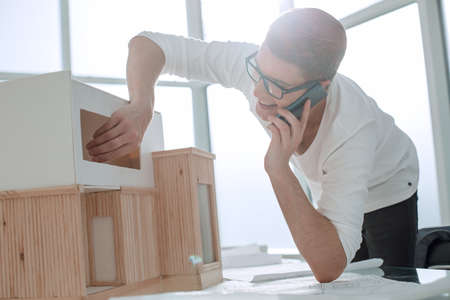 close up.smiling designer with smartphone looking at new layout .photo with copy spaceの写真素材