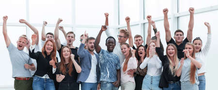 team of happy young people showing their success