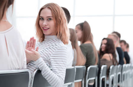 close up. young woman sitting in a row with her associates.