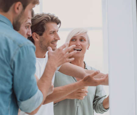 group of employees standing in the office lobby