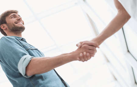 business men shaking hands in the office lobby
