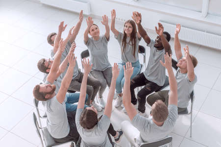 group of young people joining their hands together