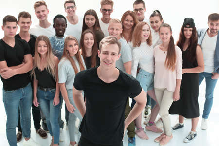 confident guy standing in front of a group of young peopleの写真素材