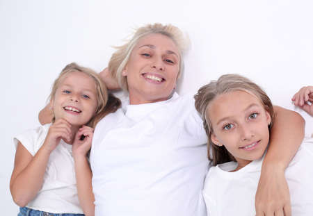 happy mom with her two daughters looking at the camera