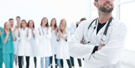 top view. a group of smiling doctors pointing at you. photo with copy space