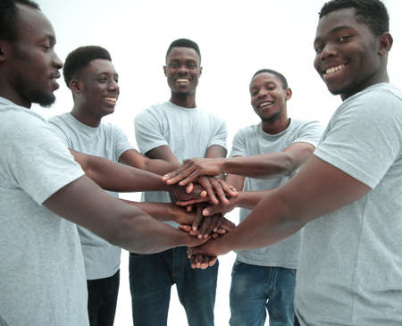 group of diverse guys making a tower out of handsの写真素材