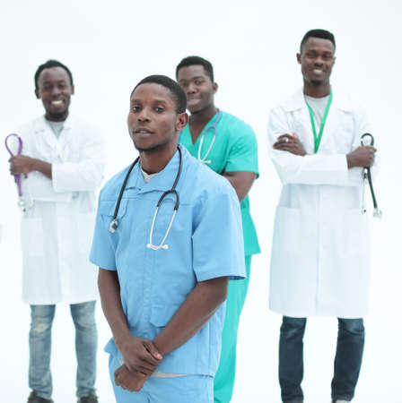 young medic standing in front of his friends colleaguesの写真素材