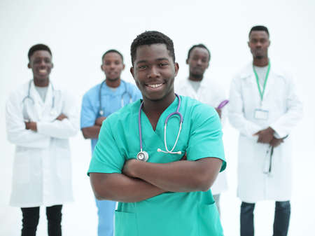 smiling surgeon standing in front of his colleaguesの写真素材