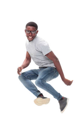 cheerful guy in glasses jumping high up . isolated on whiteの写真素材