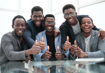 group of smiling employees giving a thumbs upの写真素材