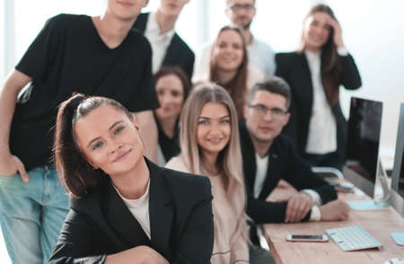 group of young professionals sitting near the desktop