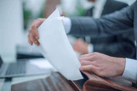 close up. businessman opening briefcase sitting at office Desk. business concept
