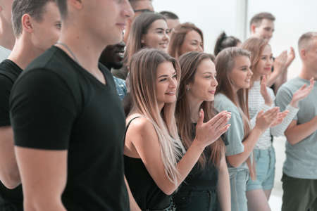 group of diverse young people applauding their leaderの写真素材