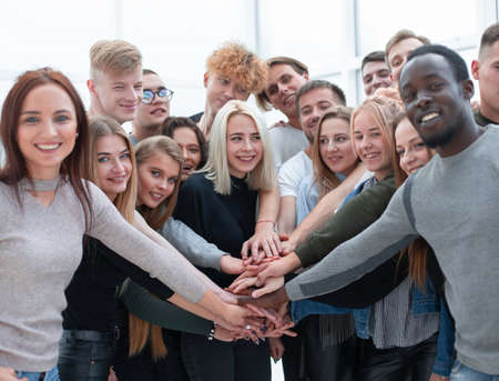 diverse young people putting their hands togetherの写真素材