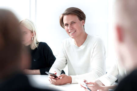group of young people sitting at a round table