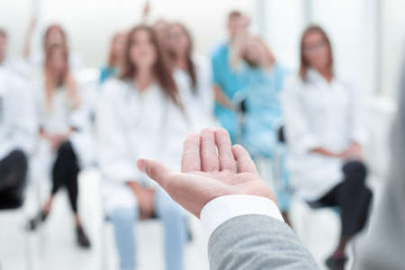 top view. a group of smiling doctors pointing at you. photo with copy space
